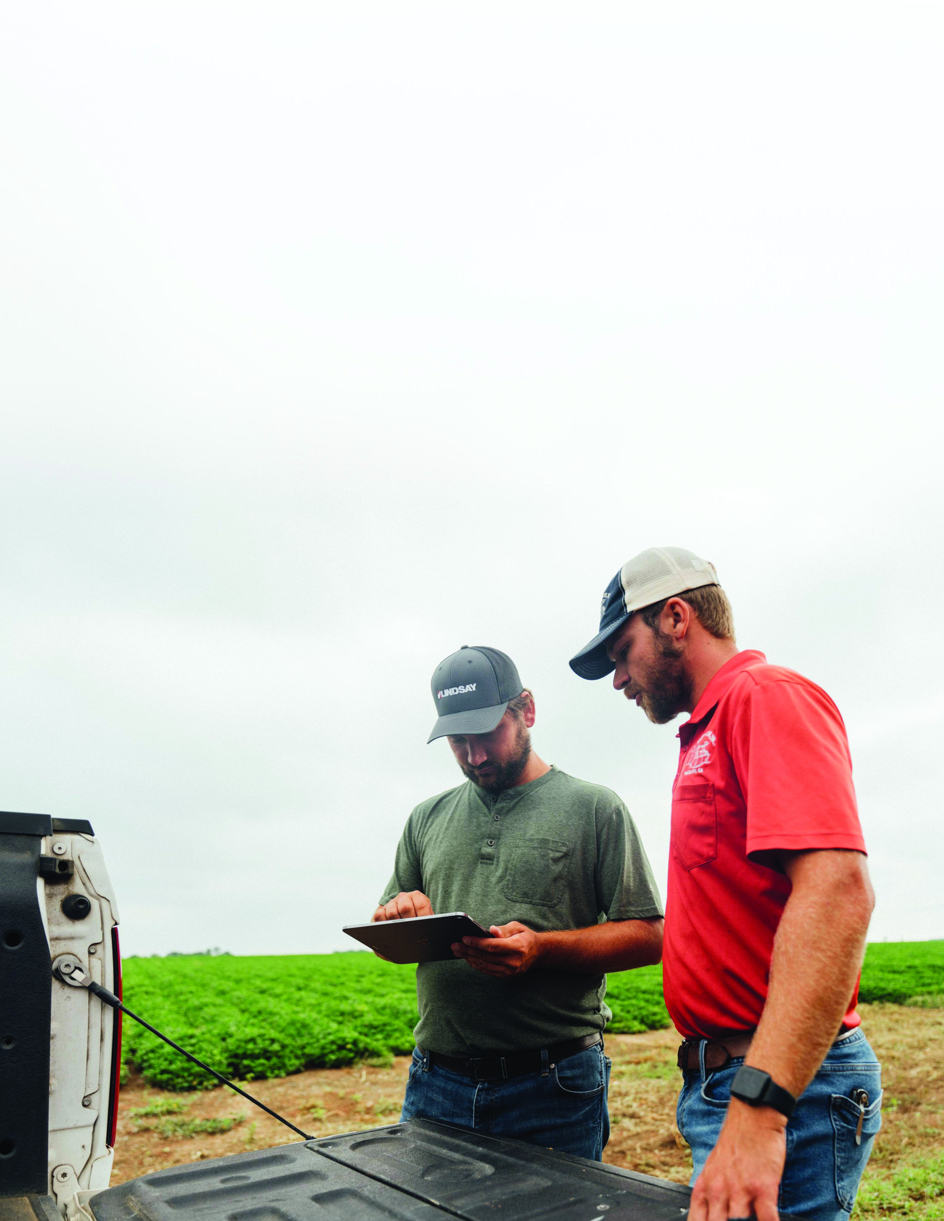 Farmers using FieldNET tablet in the field